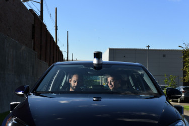 PITTSBURGH, PA - OCTOBER 17: Systems engineer, Prasad Venkiteswaran, left, and software engineer, Erick Fuentes work on testing a Volkswagen Golf that is equiped with self-driving technology outside Aurora Innovatio